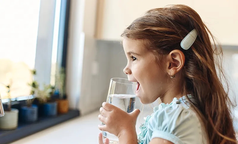 Small child with glass of water