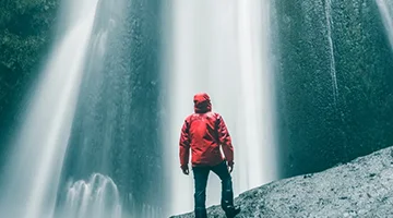 Man standing infrond of a waterfall